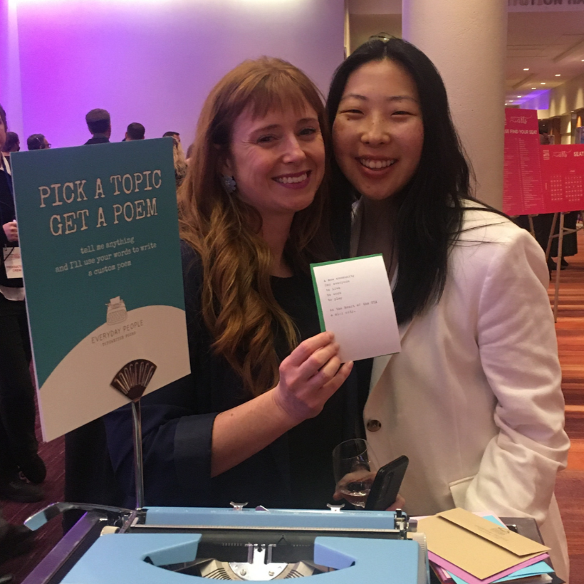Guests holding personalized typewriter poem at a gala fundraiser in Toronto
