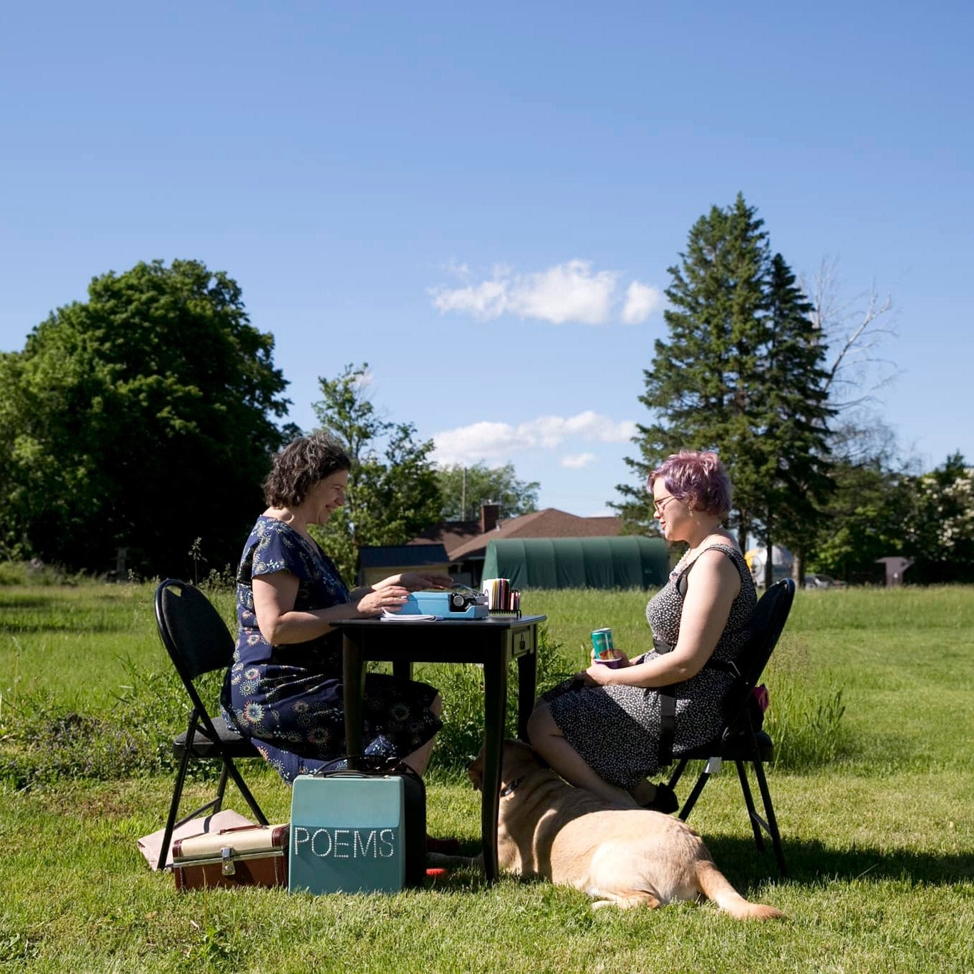 Typewriter poet creating a custom poem for a guest at an outdoor party