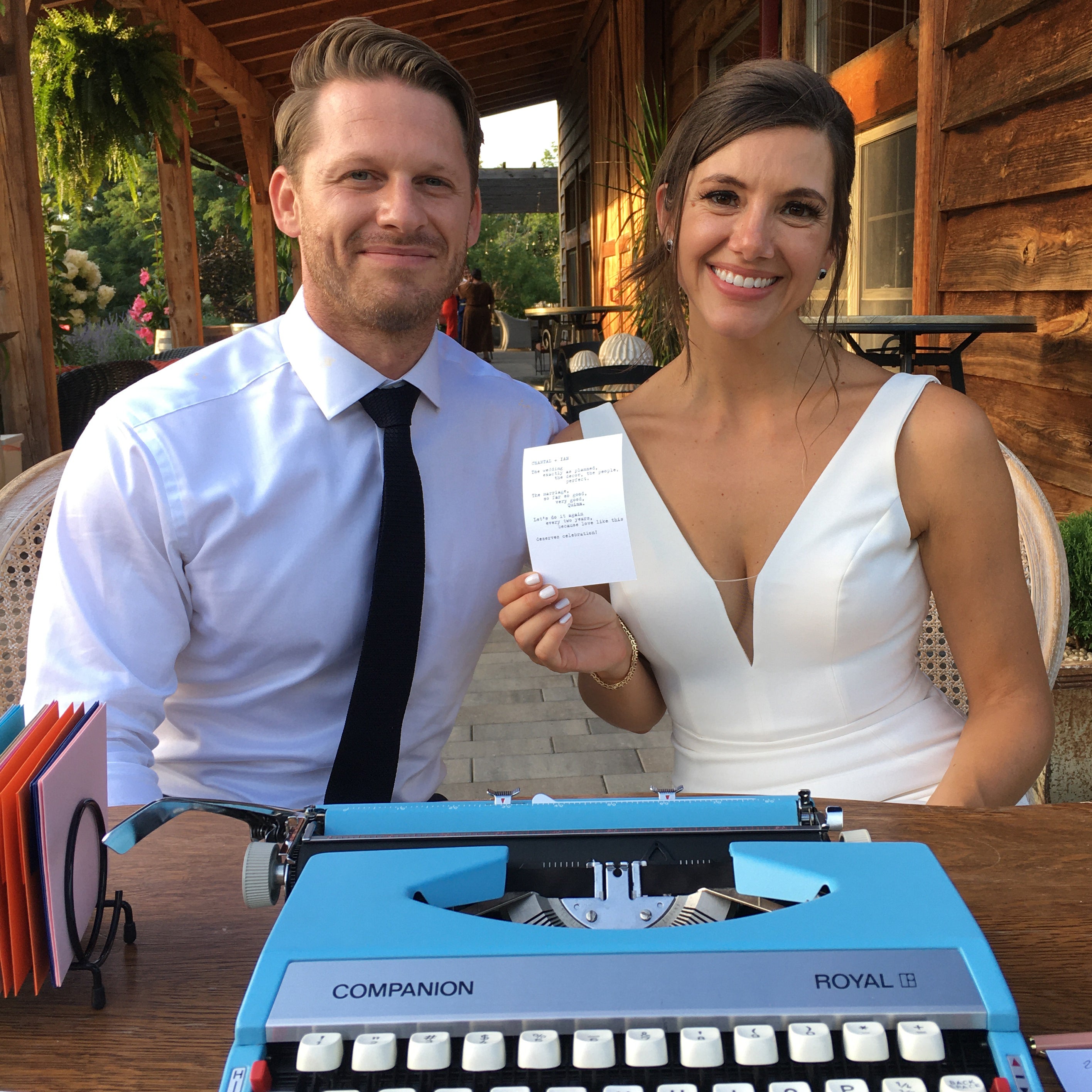 Couple holding a custom poem at their wedding reception